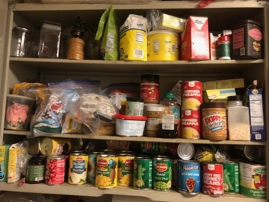 Pictured are shelves stocked full of non-perishable goods.