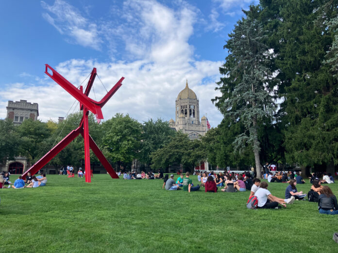 Students gather on the college green.